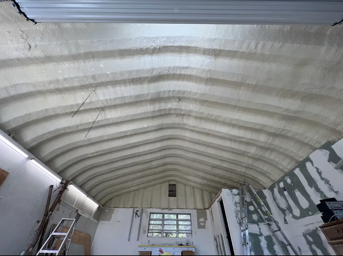Spray polyurethane foam applied to the underside of a metal roof deck in Petal